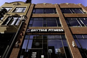 Outside view of a three-story Anytime Fitness gym built with brick, with anytime fitness signage